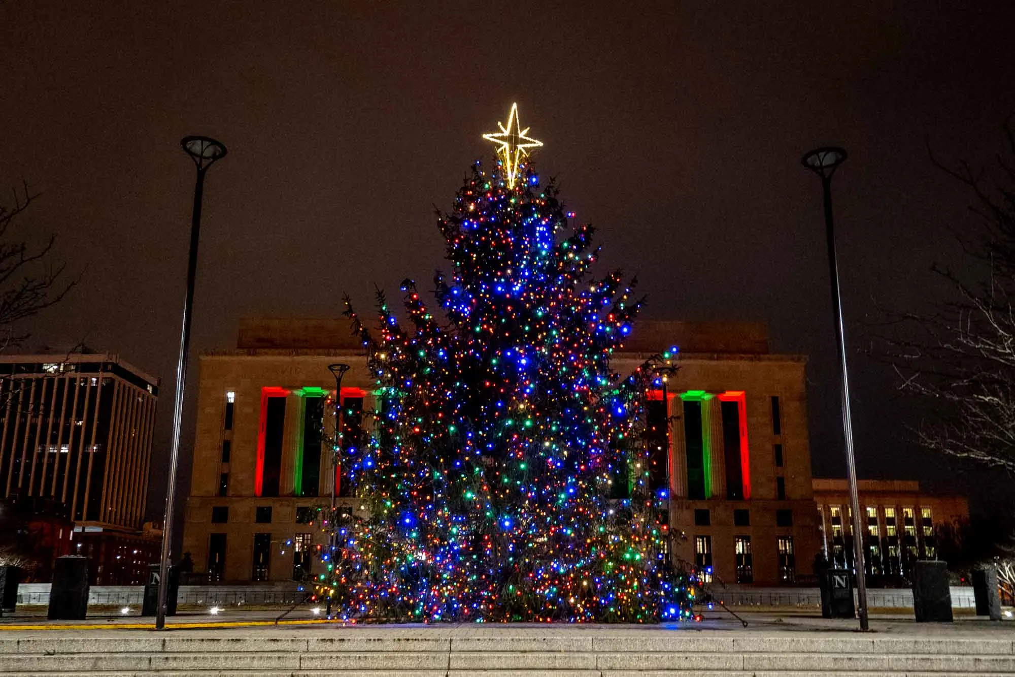 35-foot-tall Christmas tree lit up at night in a city square.