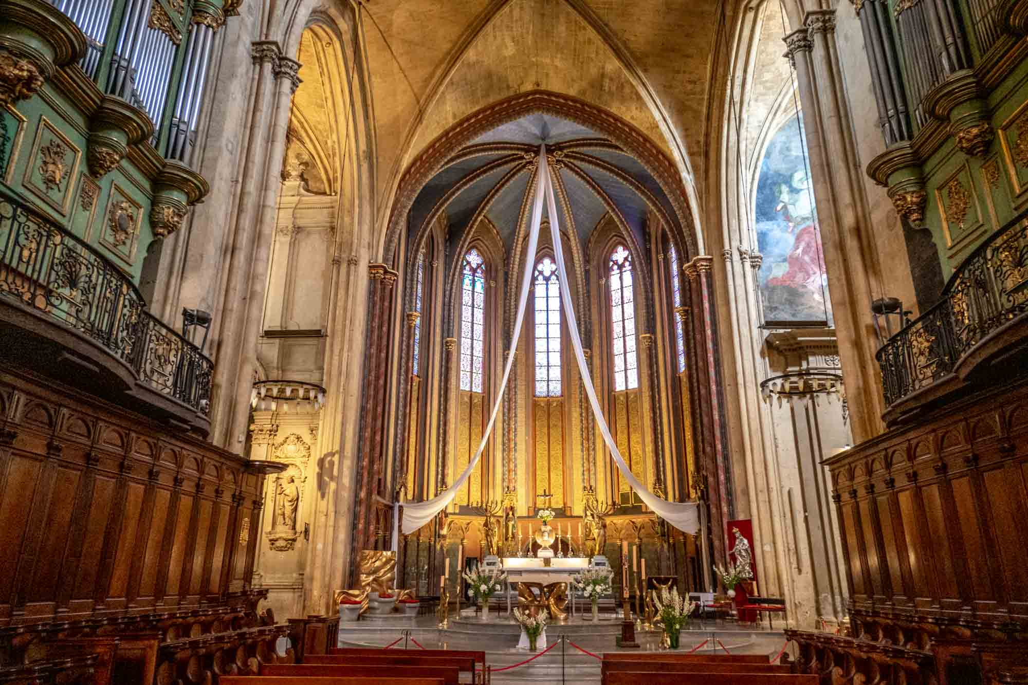 Interior of a cathedral sanctuary with a pipe organ and vaulted ceiling