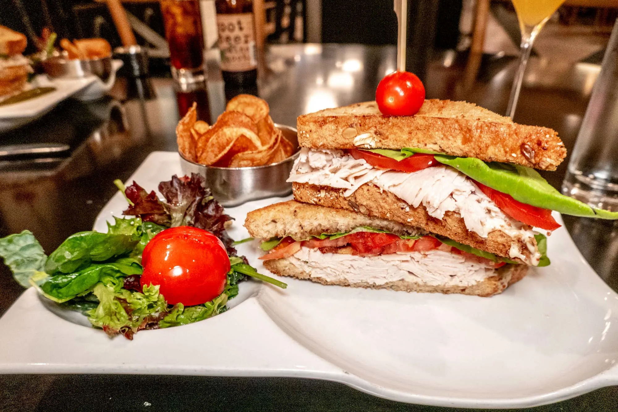 Club sandwich and chips on a plate.