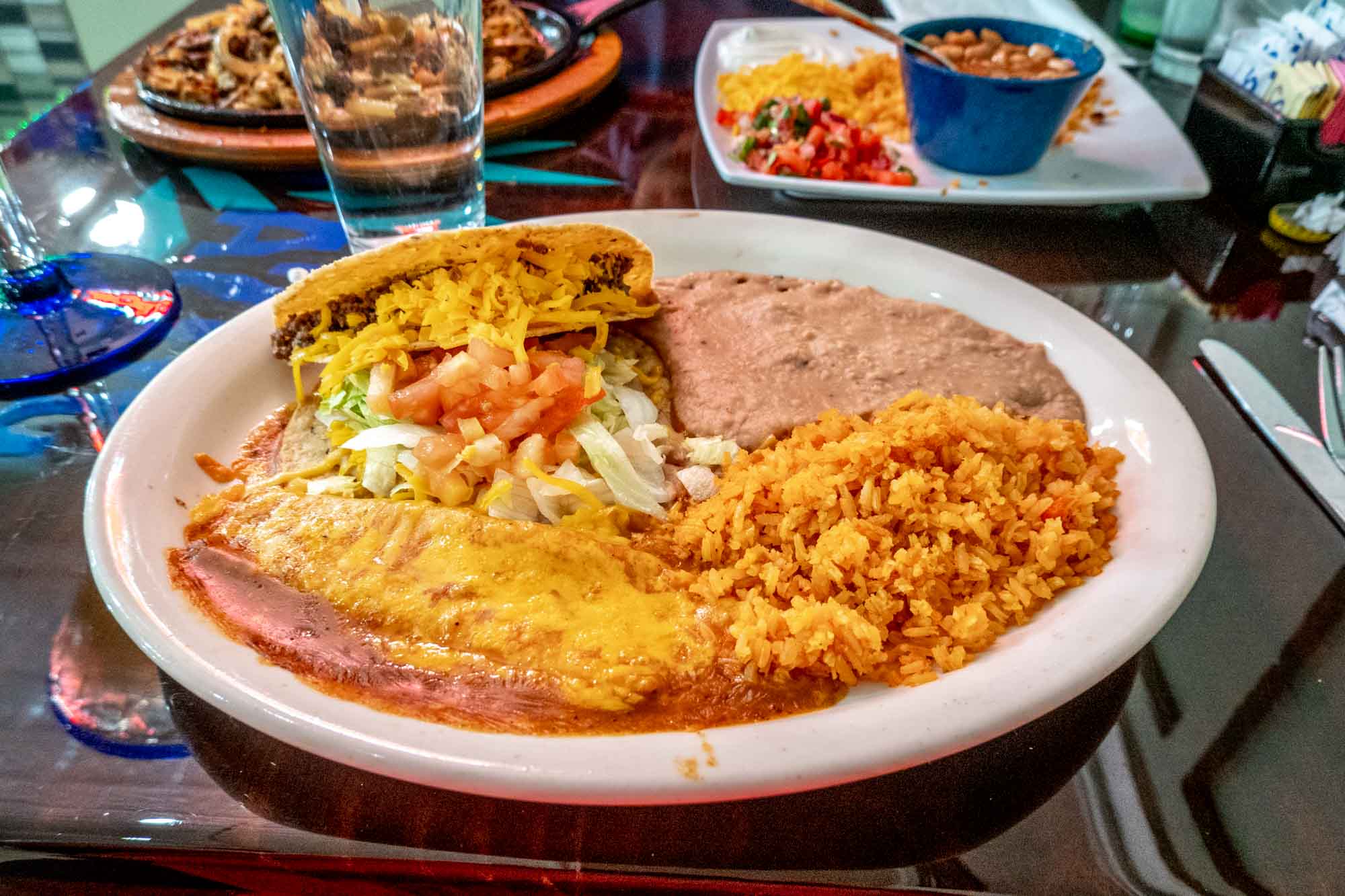 Tacos, enchiladas, and other Tex-Mex foods on a table in a Mexican restaurant