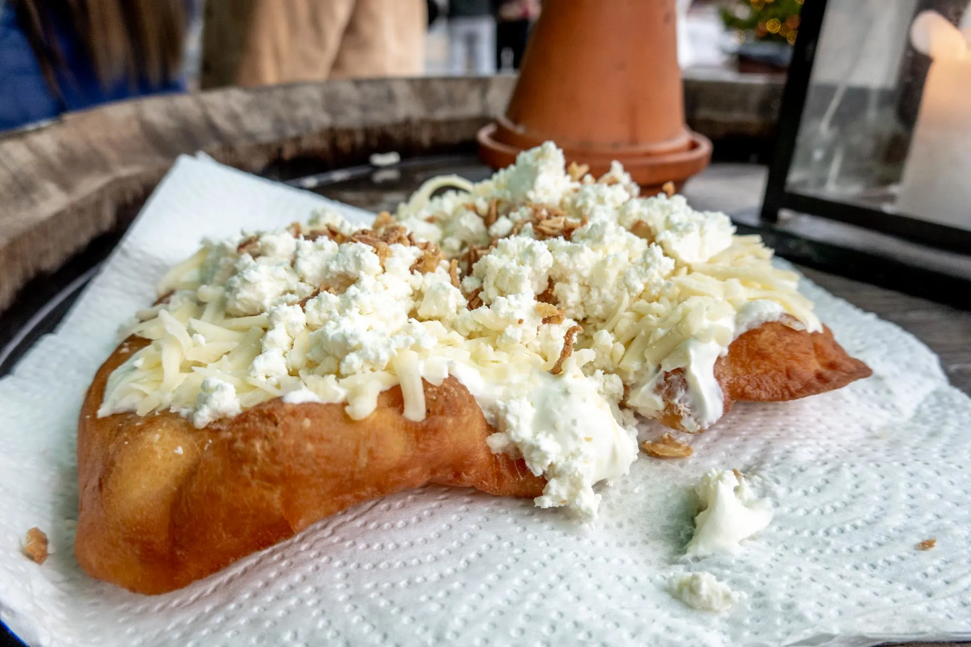 Langos bread topped with cheese and sour cream