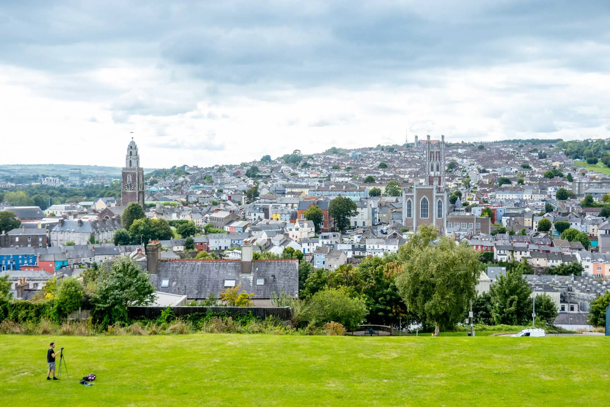 Park overlooking the city of Cork, including churches and numerous buildings on a hill