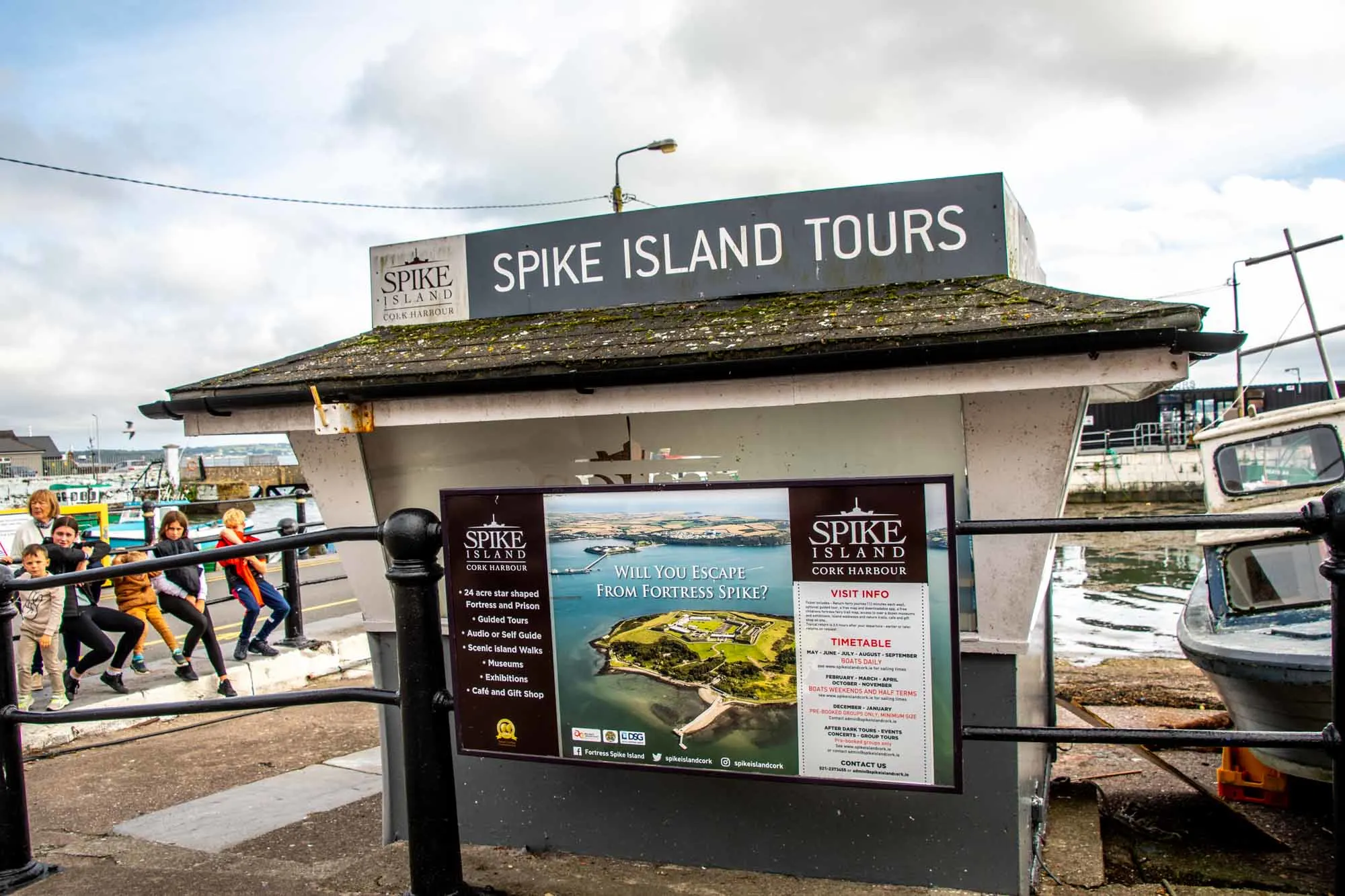 Kiosk with a sign for "Spike Island tours" and advertisement for the tours