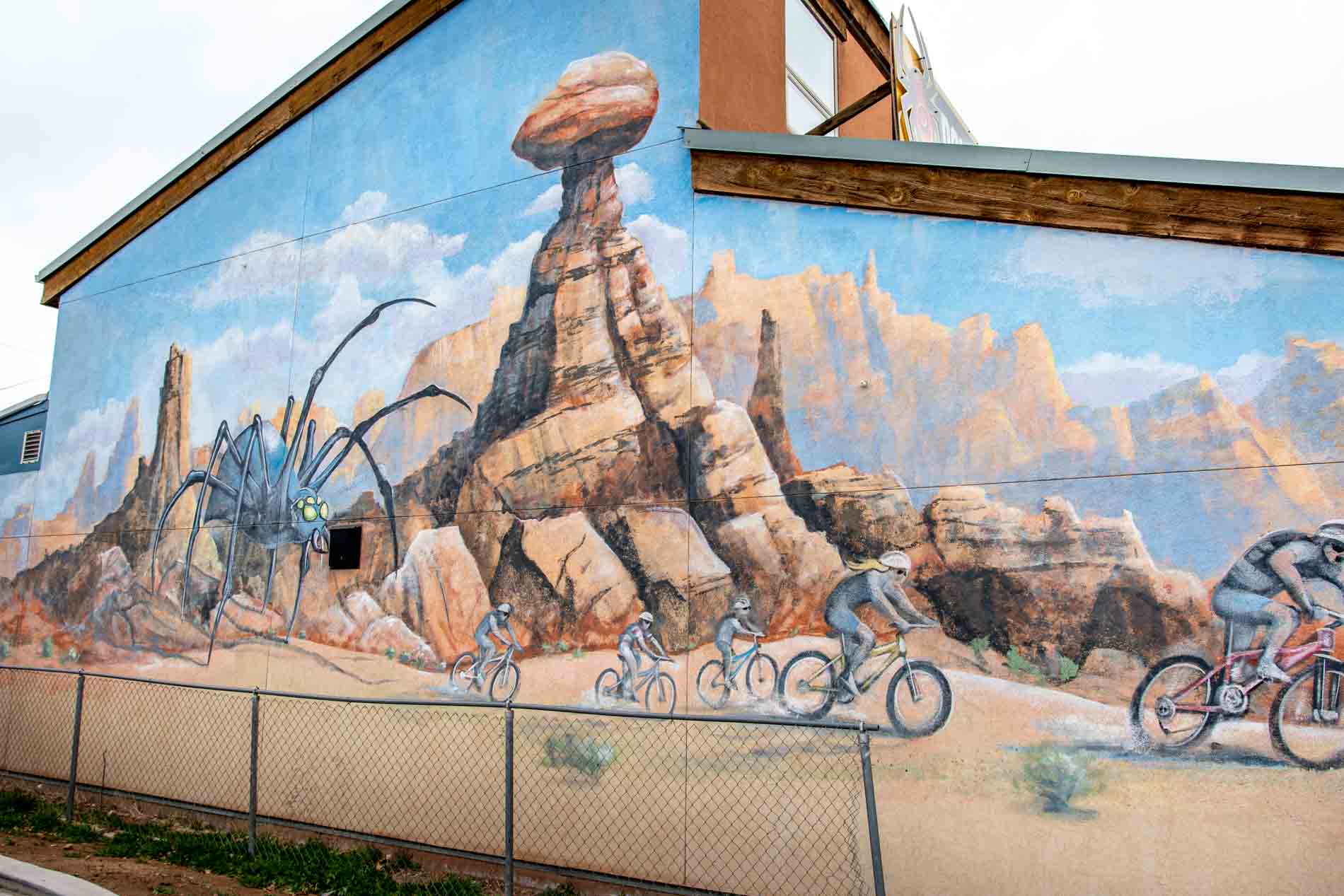 Artistic mural of mountain bikers in front of the balanced rock
