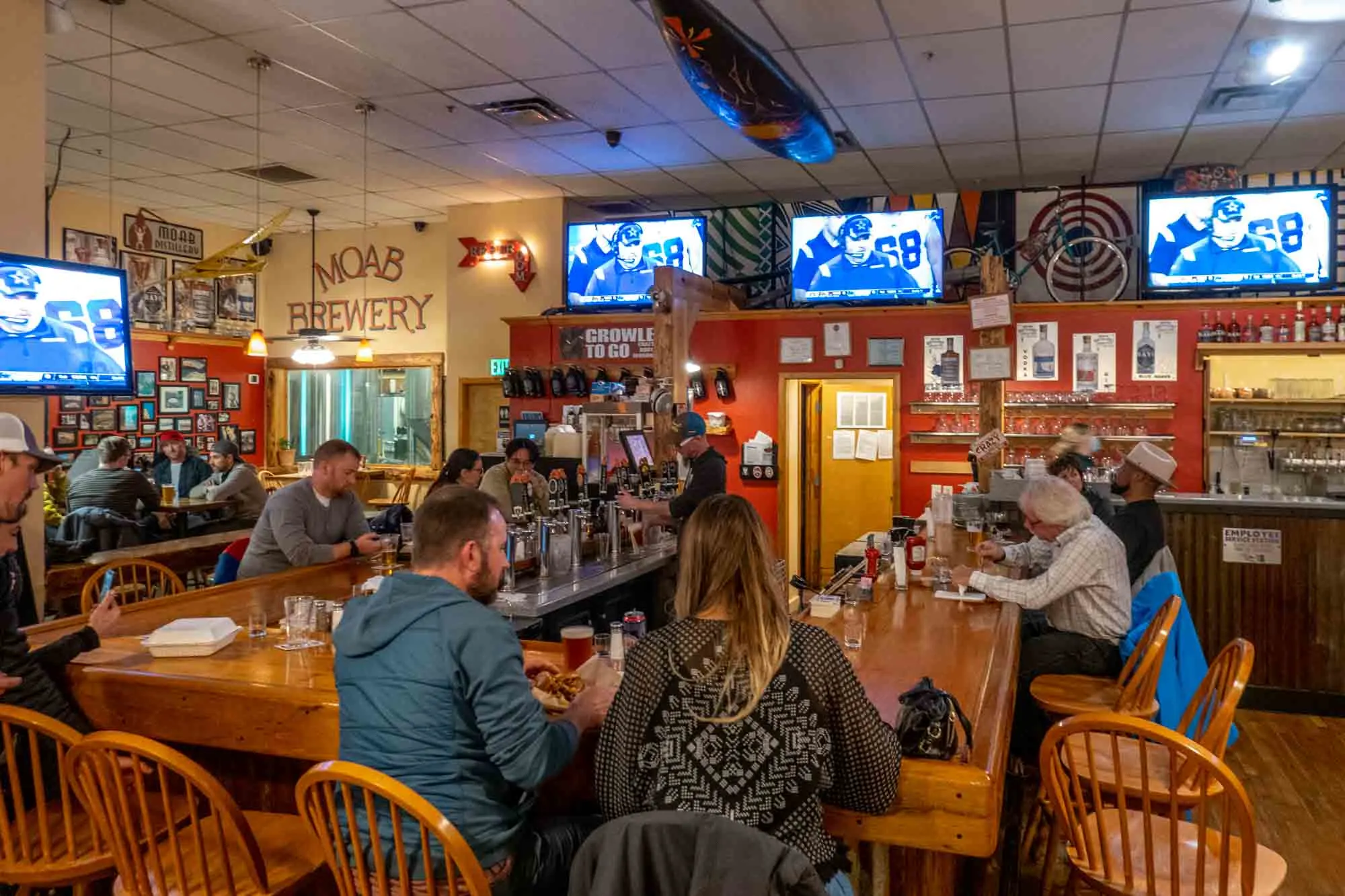 People at the bar inside Moab Brewery