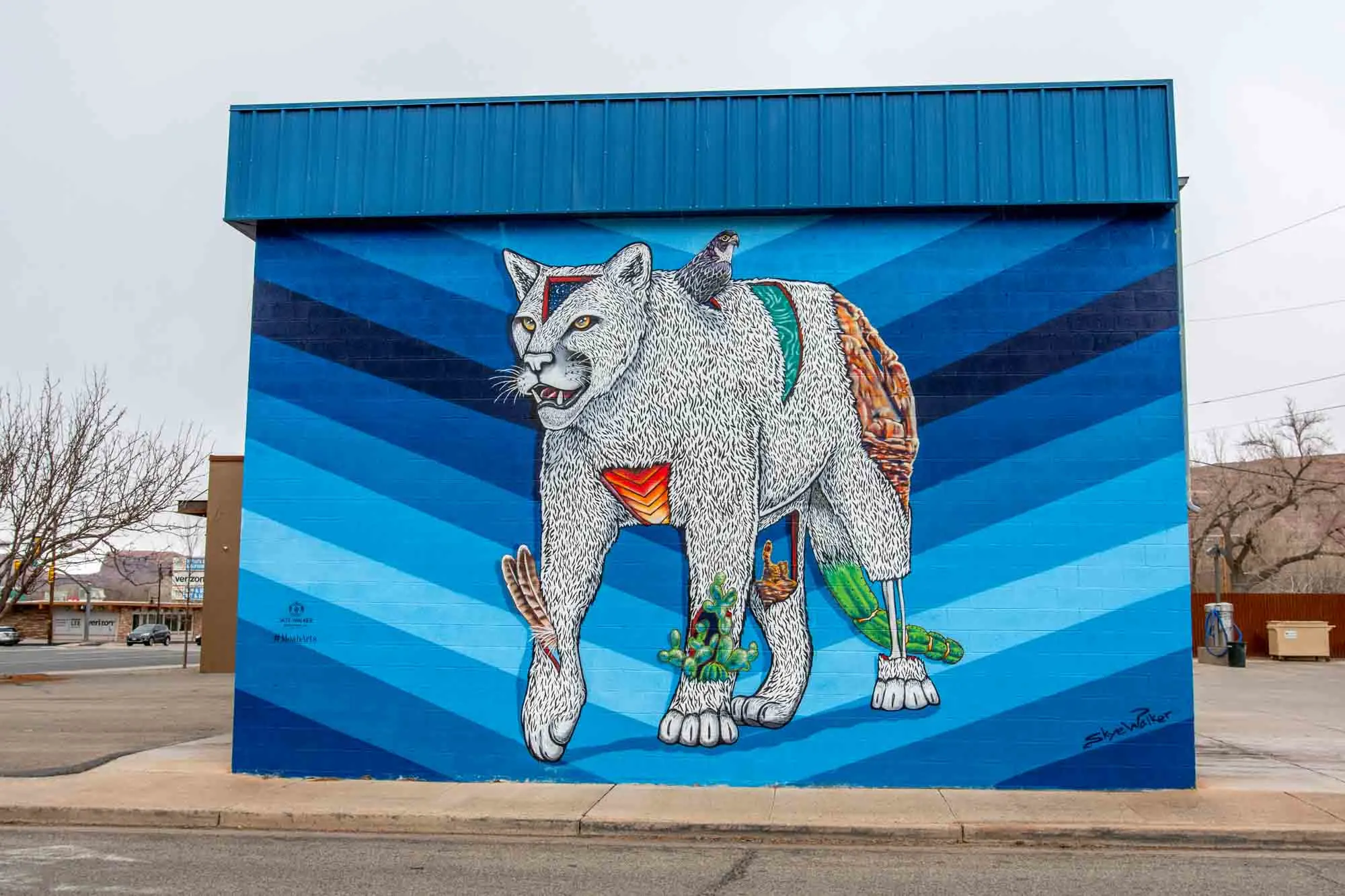 White mountain lion mural against a blue background