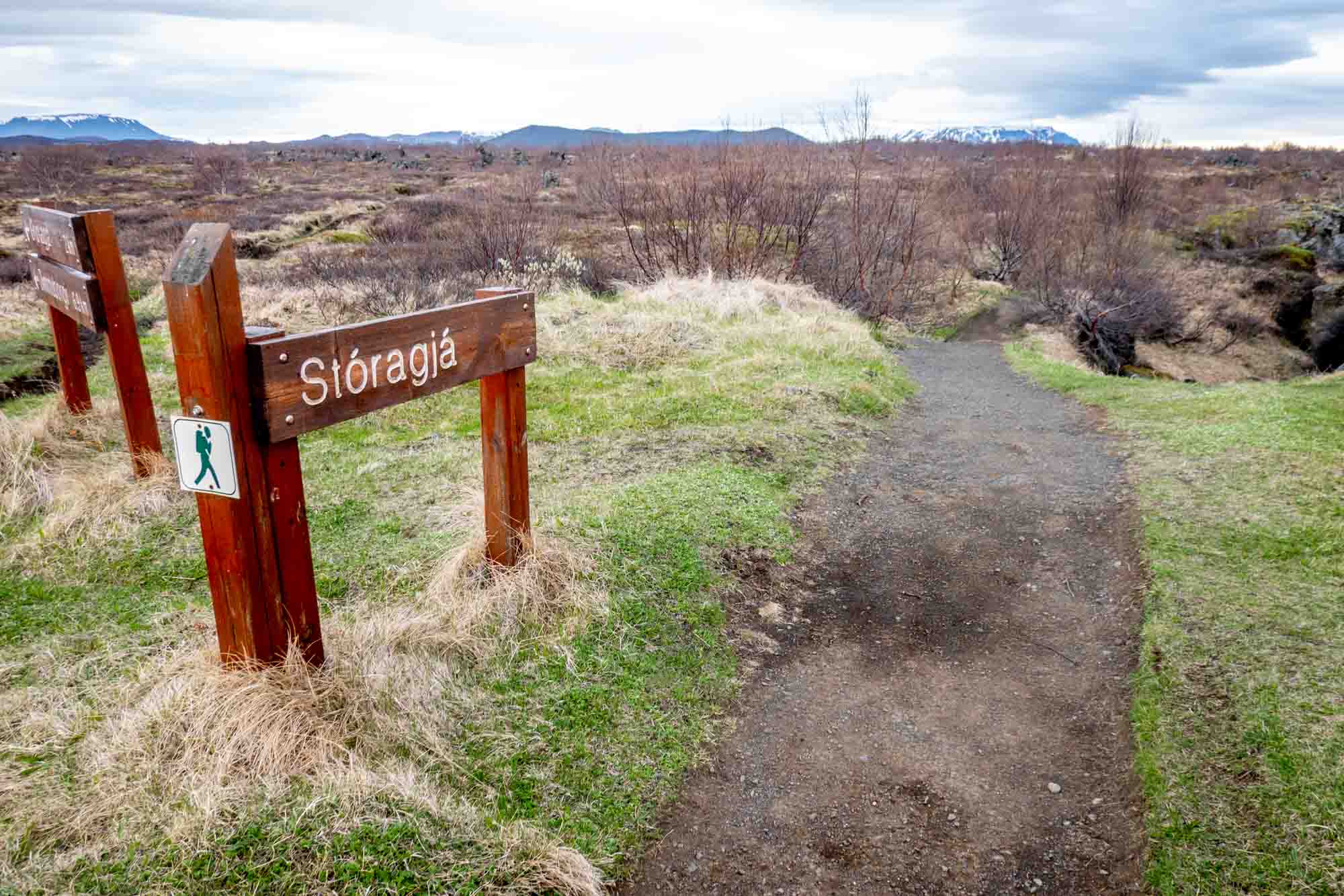 Wooden Stóragjá sign along the trail