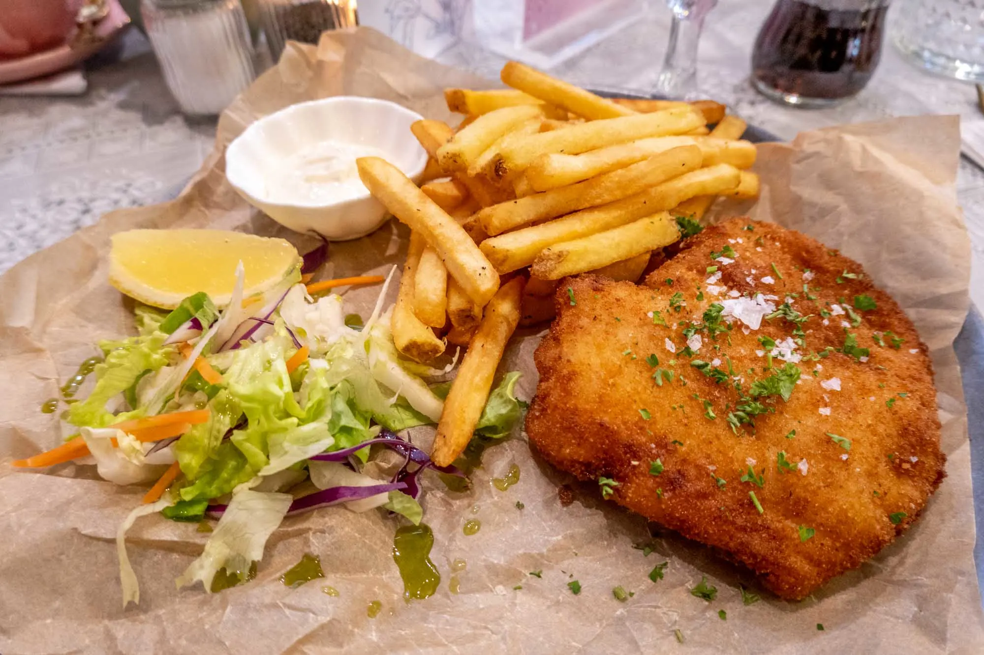 Fish& chips with salad on brown paper