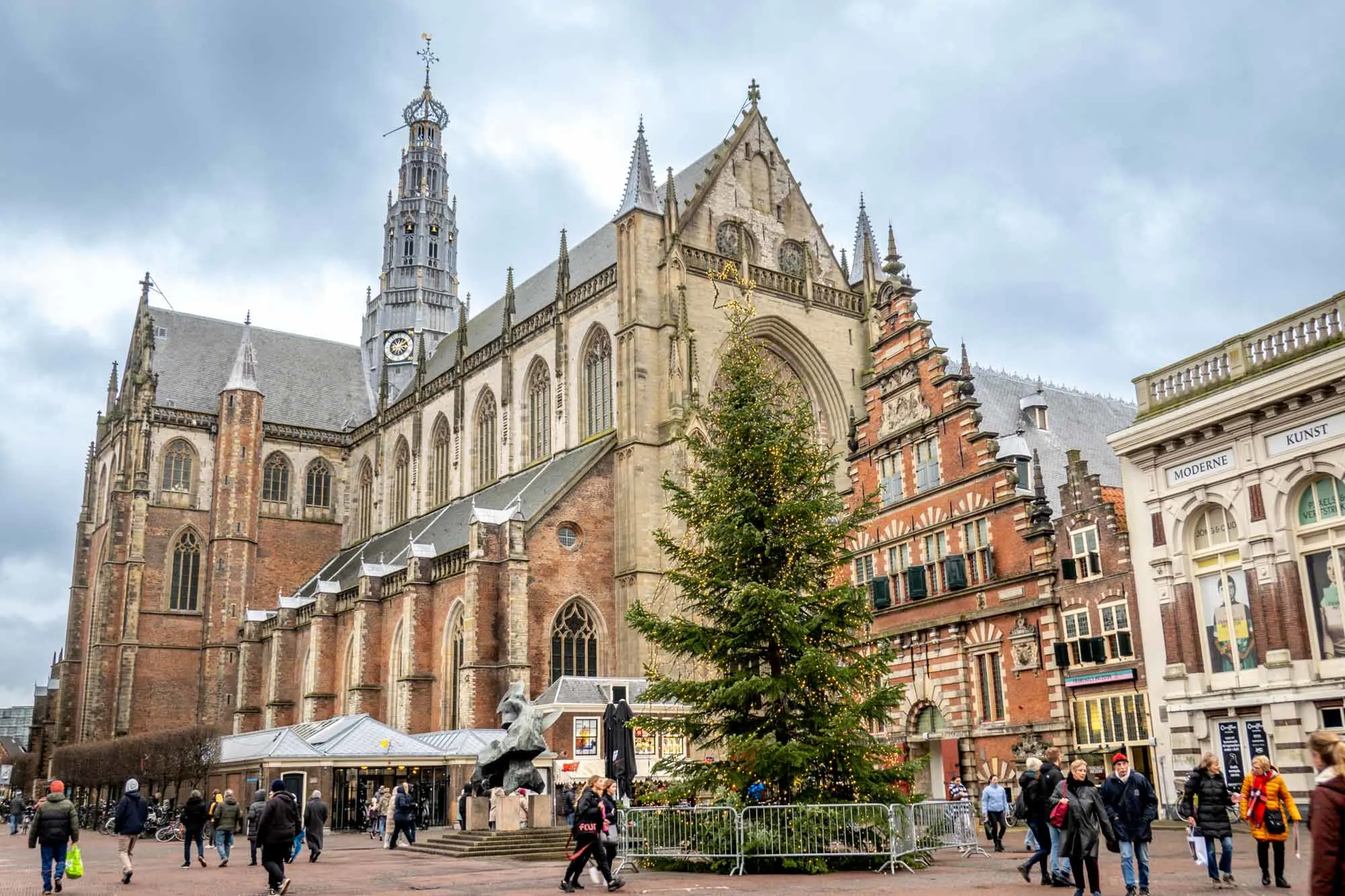 Christmas tree beside a church in a city square. 