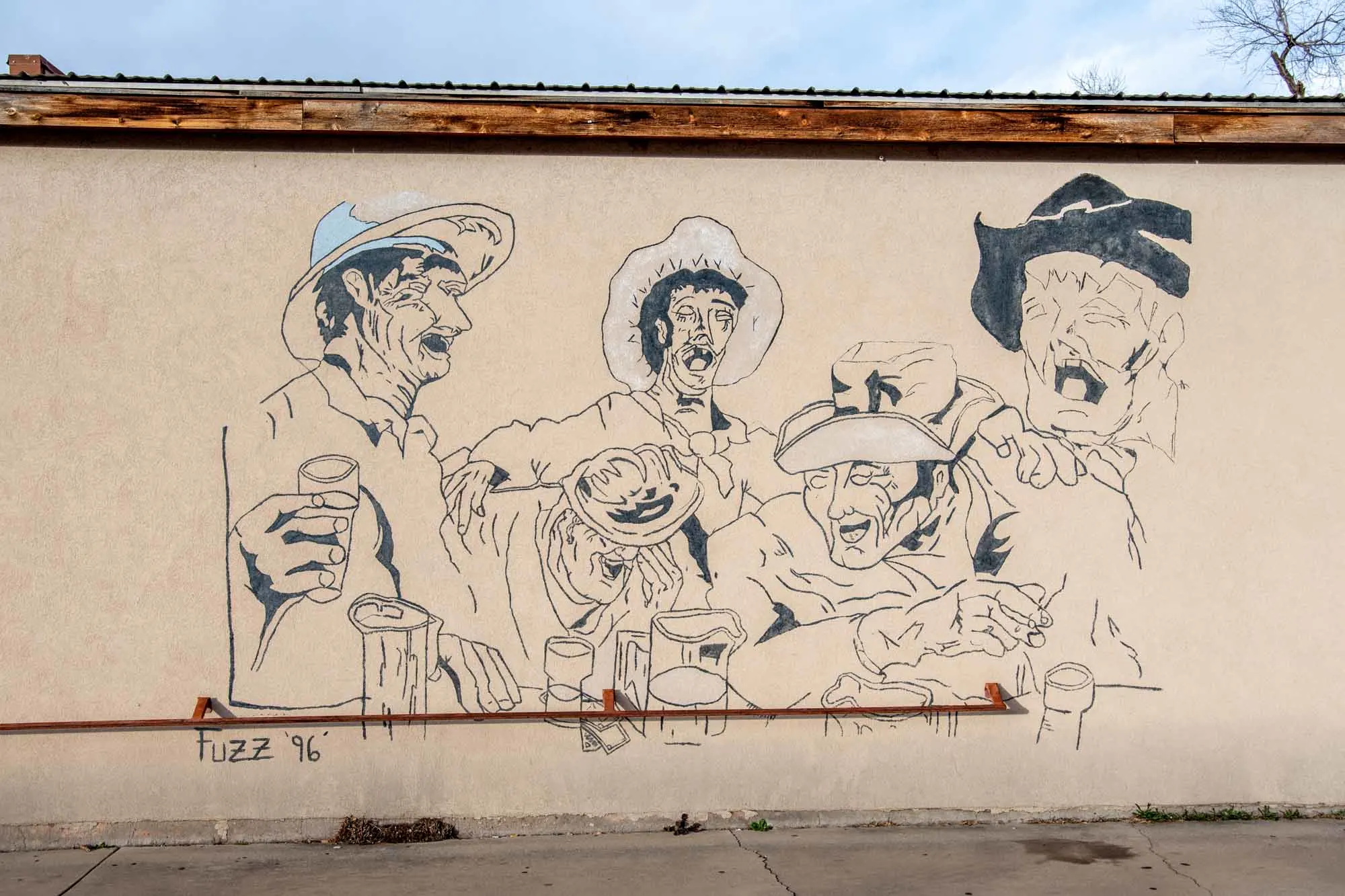 Caricature mural of 5 men in cowboy hats drinking