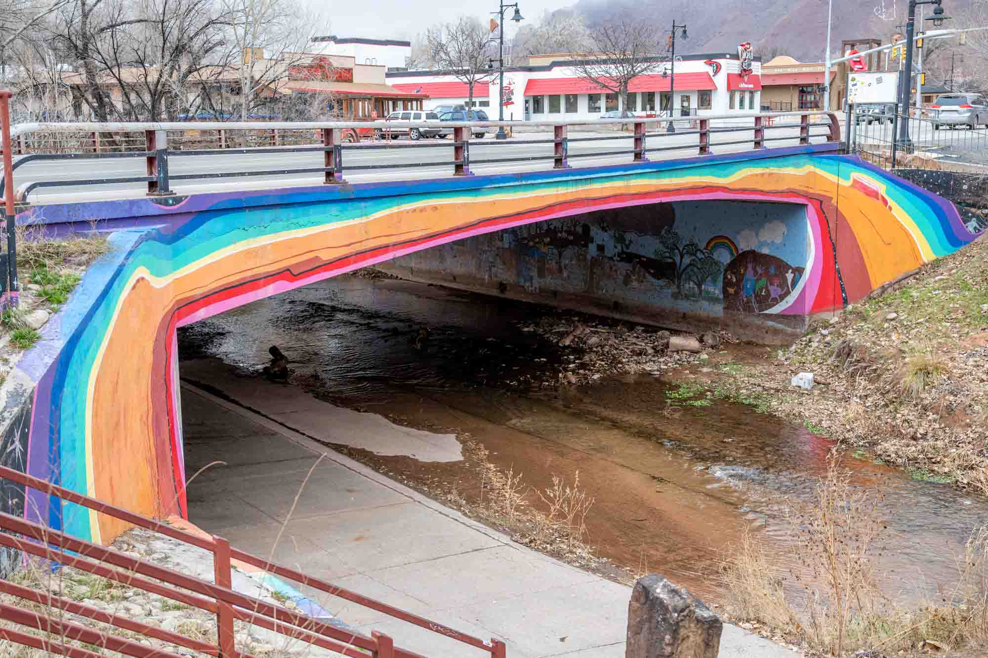 Rainbow painted bridge over river