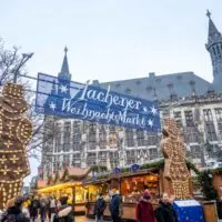 Gingerbread men beside a sign for the Aachen Christmas market and rows of vendor stalls