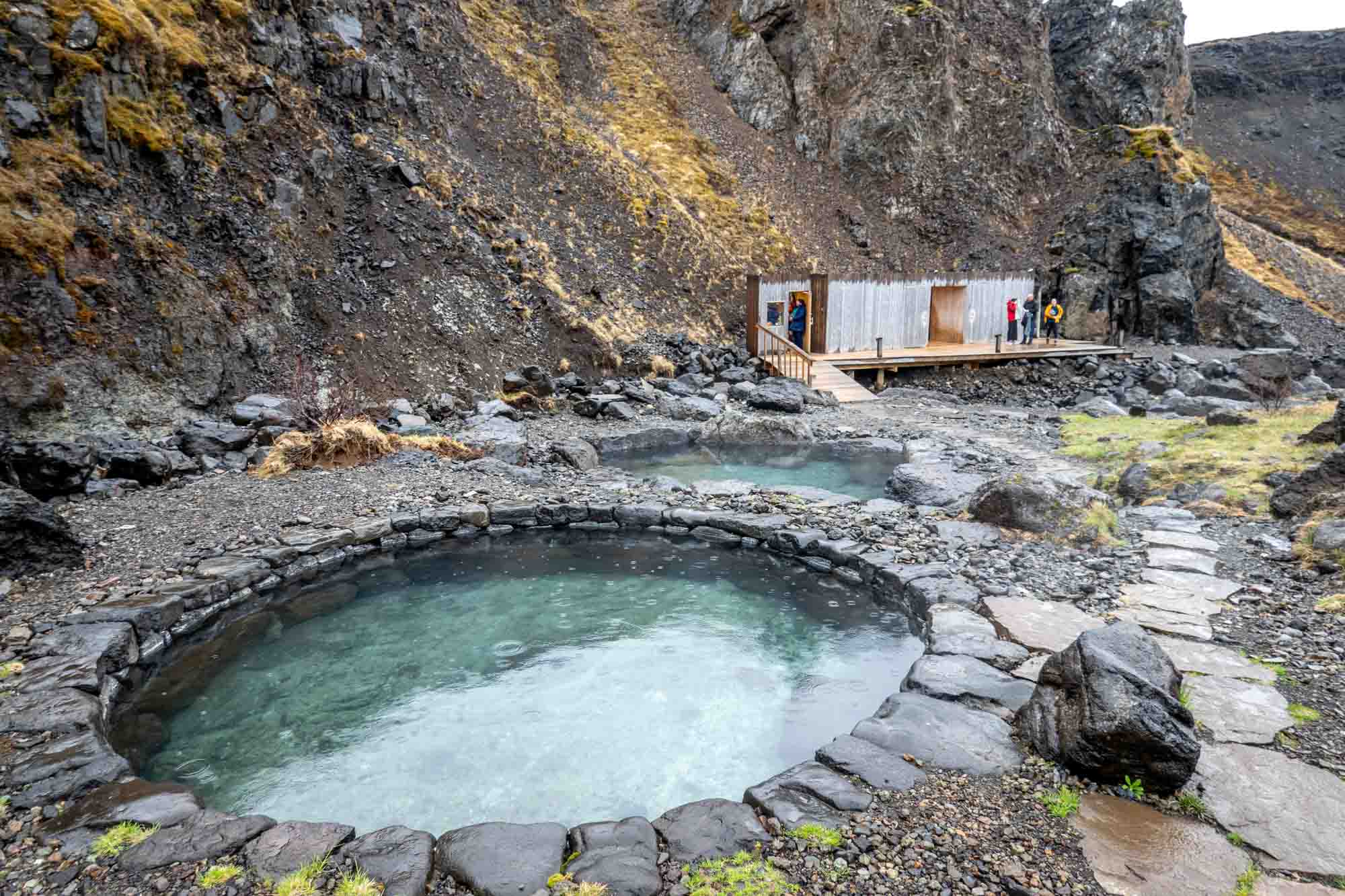 Two pools in a deep canyon with wooden changing booth