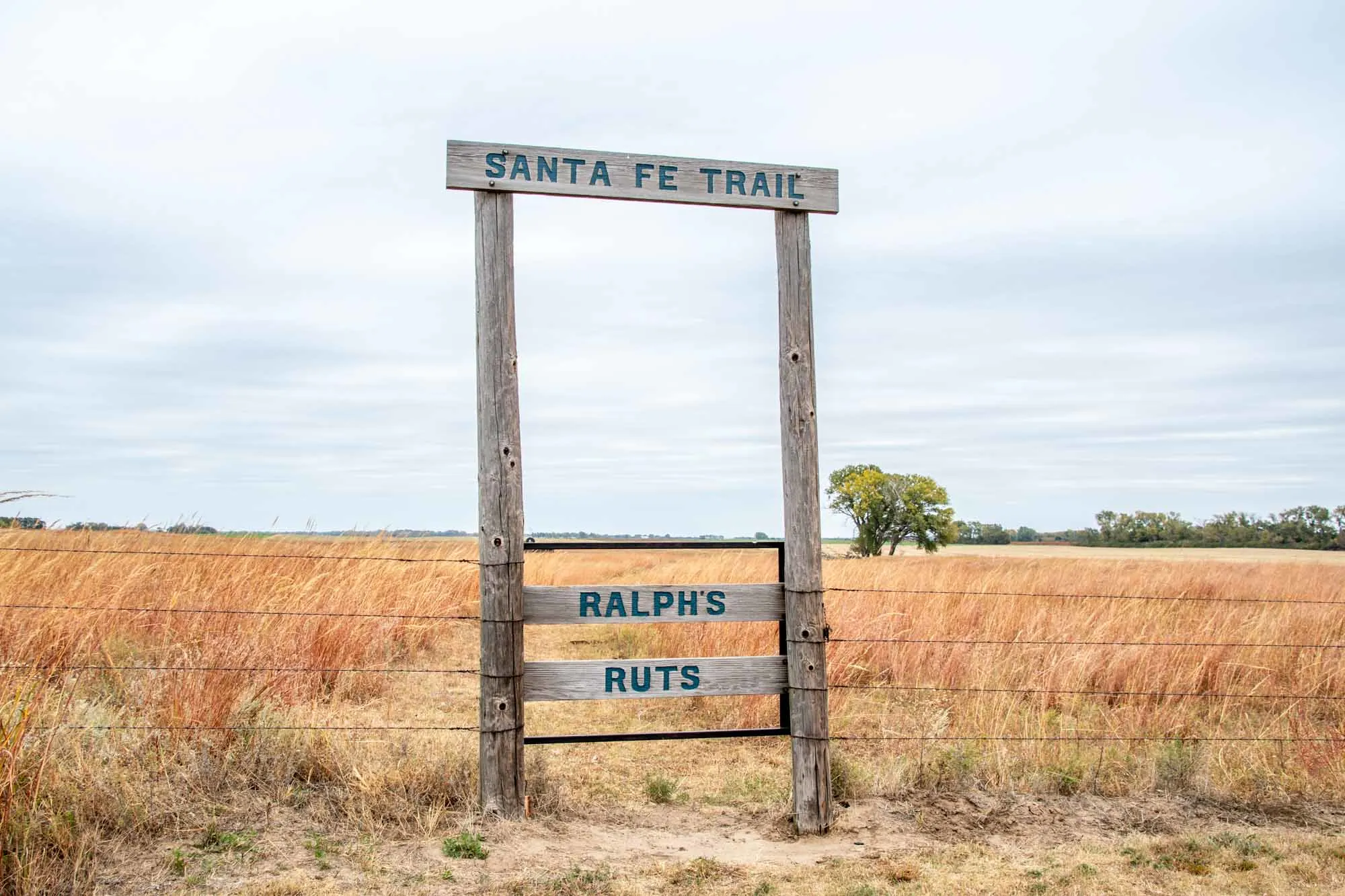 Gate on to private property. The sign reads "Santa Fe Trail Ralphy's Ruts"
