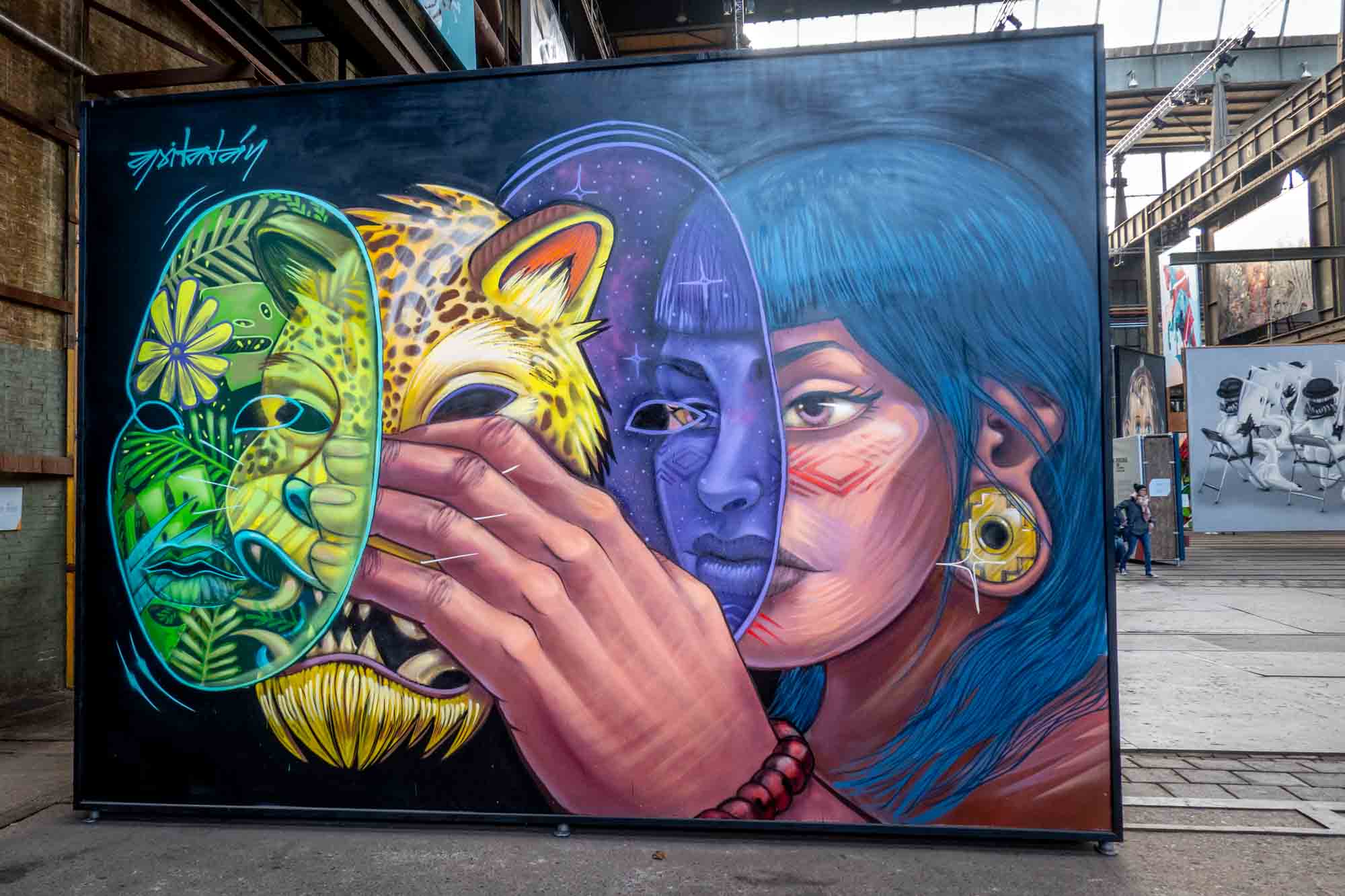 Giant mural of woman removing multiple layers of masks