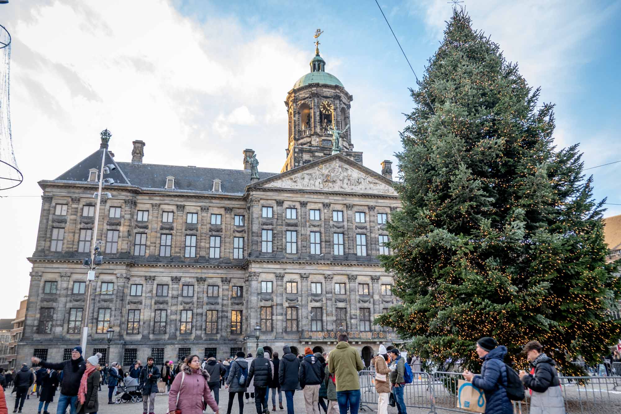 Christmas tree in a city square in front of a palace.