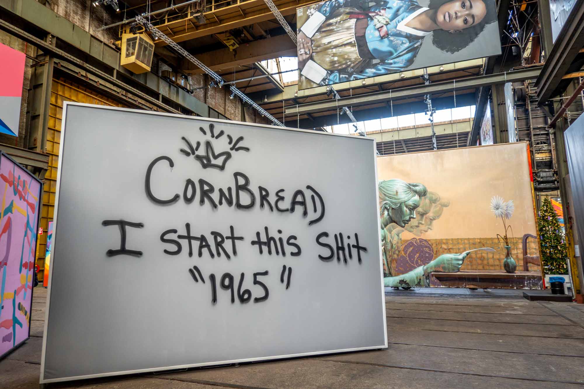 Large canvas that has a crown spray painted with the words: CornBread I Start this Shit "1965"