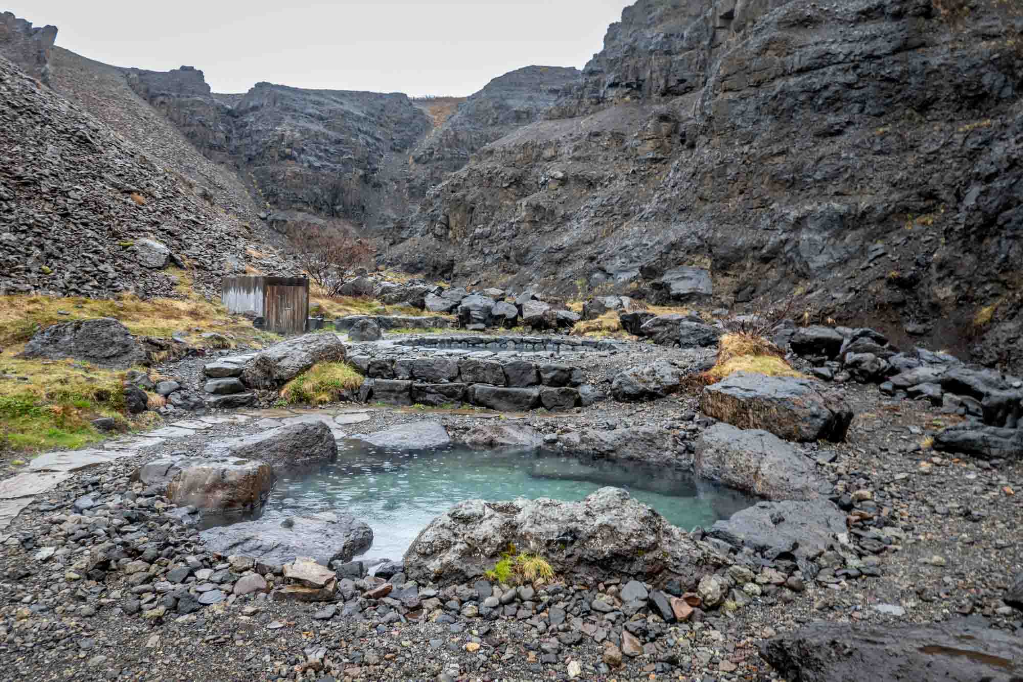 Two hot springs pools in a rocky canyon