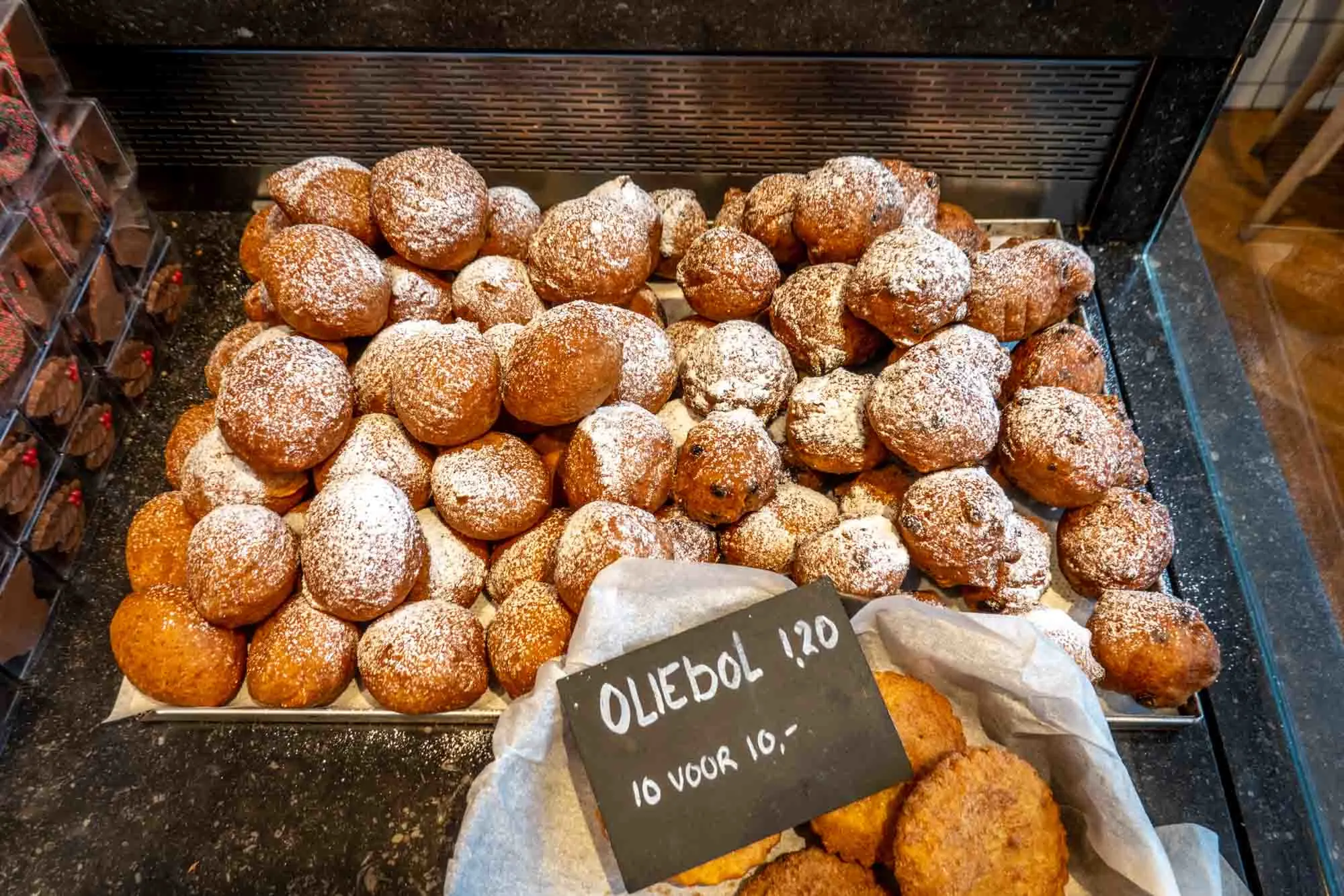 Oliballen (Dutch donuts) dusted with powdered sugar for sale
