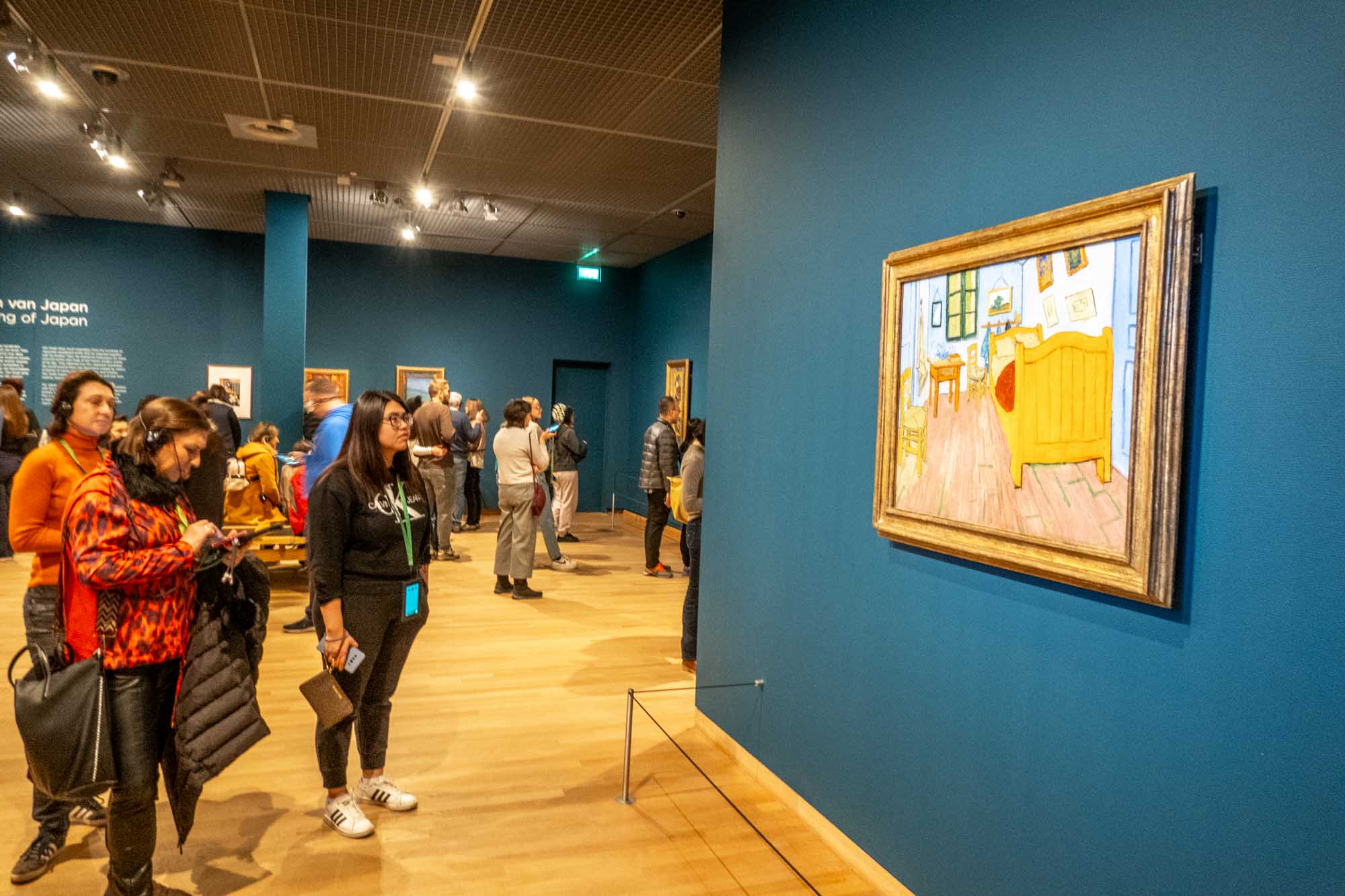 Visitors looking at a painting in the Van Gogh Museum