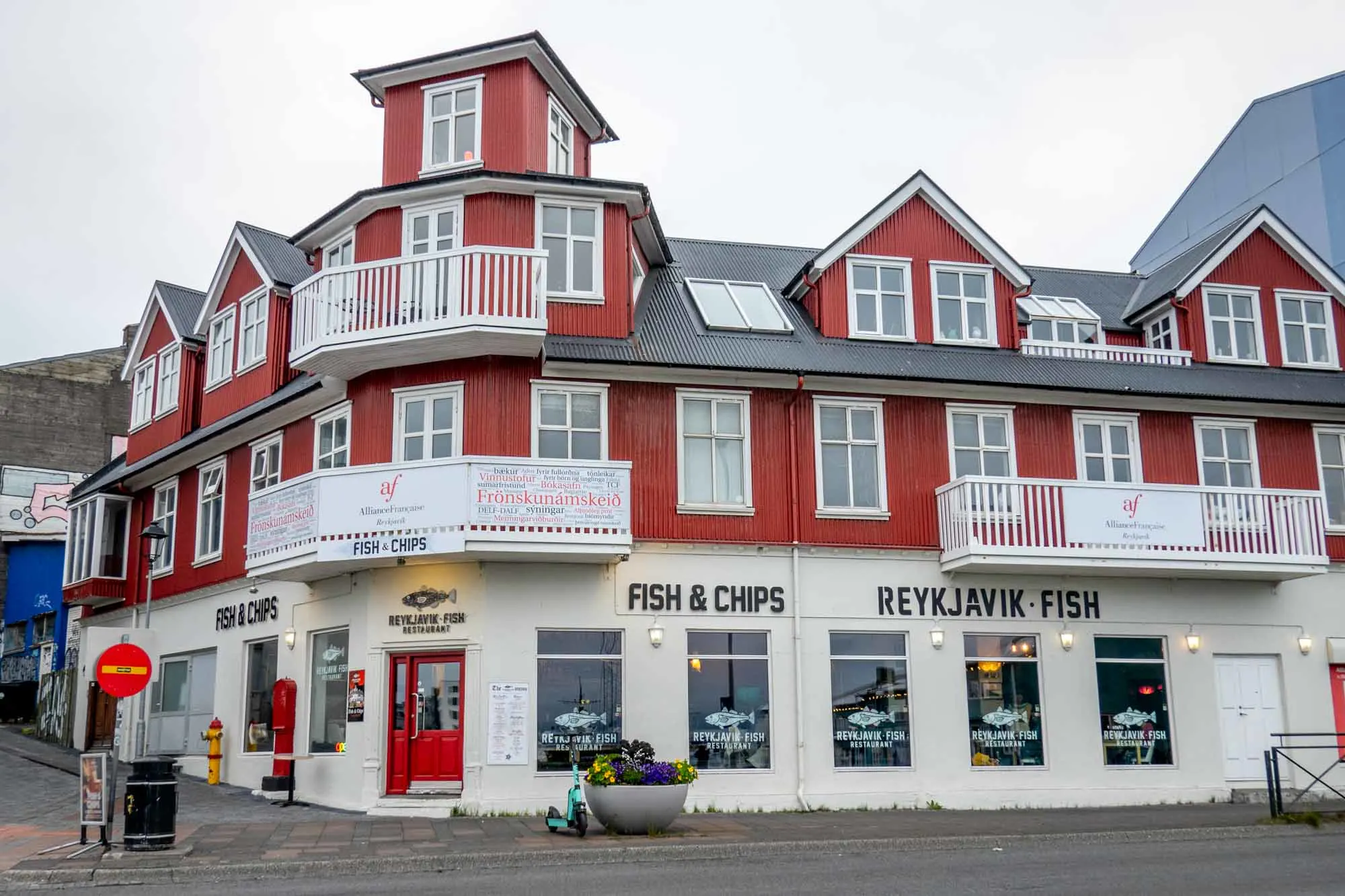 Red and white exterior of a restaurant that says "Reykjavik Fish" and "Fish & Chips"