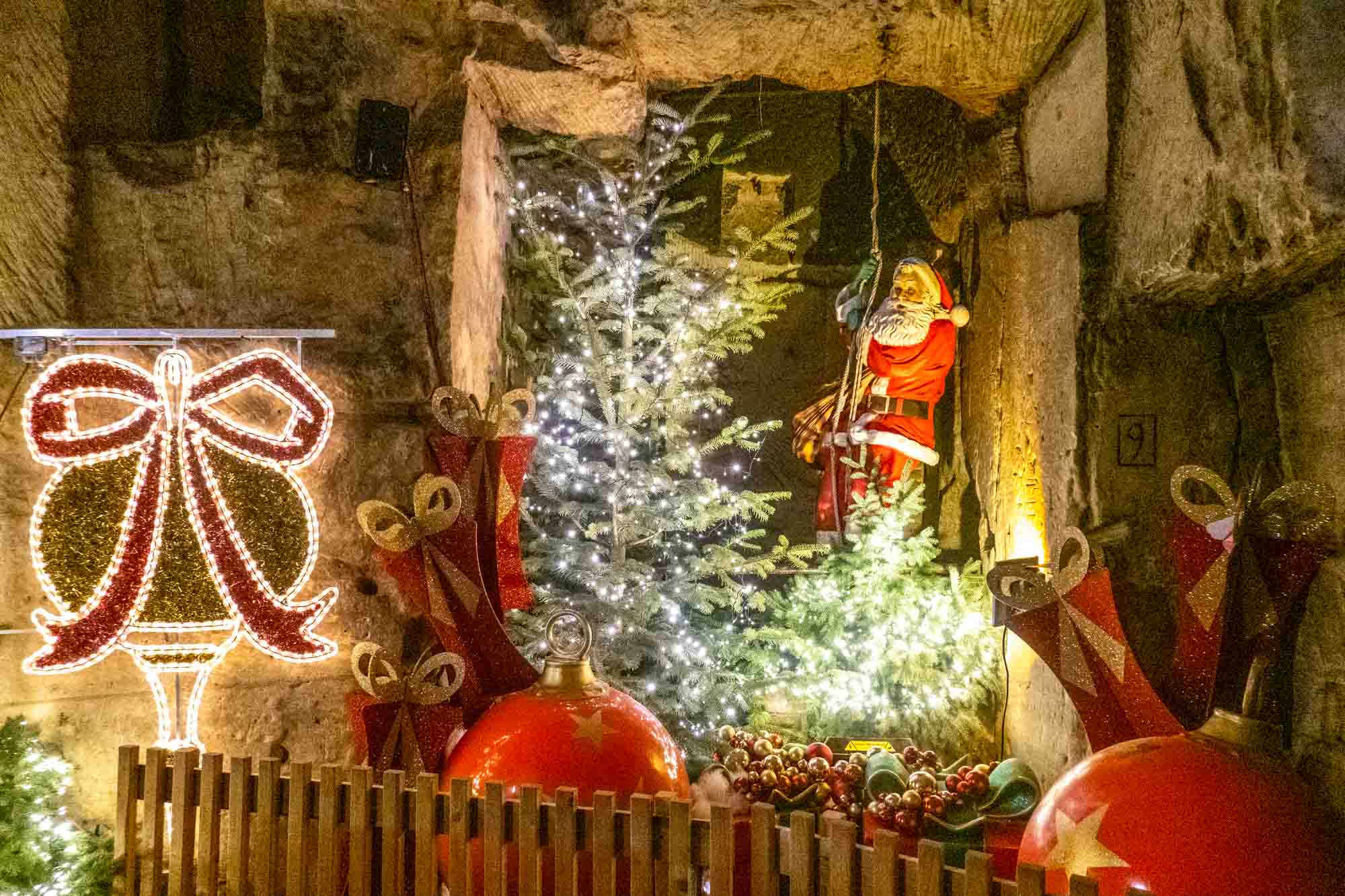 Santa, large ornaments, and Christmas light display.