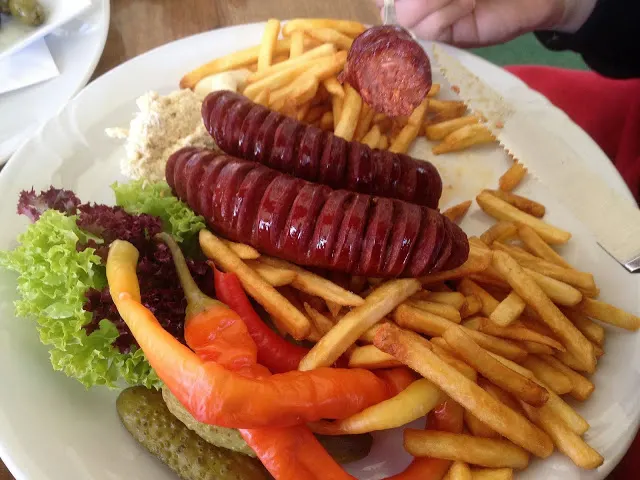 Plate of grilled sausage and fries at El Toro Negro in Prague
