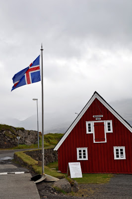 Red building and Iceland flag in Djupivogur